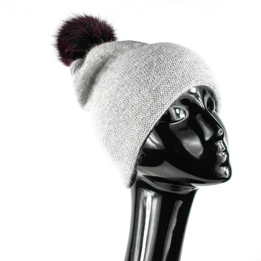 Warm stylish wool hat with purple natural fur pompom